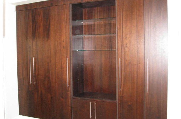 Converted wall unit featuring glass shelving